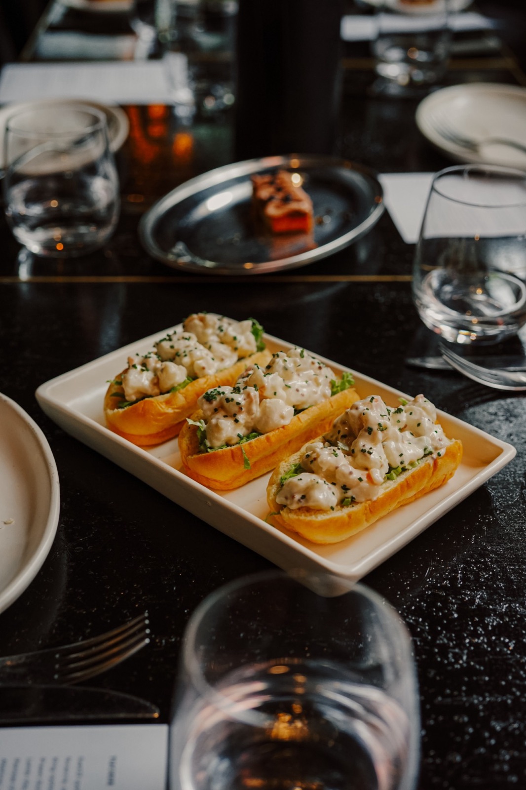 Prawn roll, lemon aioli, lettuce, chives, brioche.